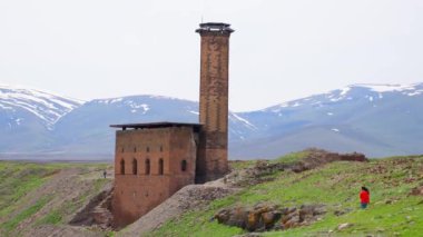 Woman tourist walk around ani archeological site in eastern anatolia, Kars region