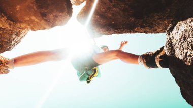 Low angle close up young caucasian sporty woman training steps on rock climb outdoors in sunny hot weather alone. Inspirational active strong woman sports activities outdoors