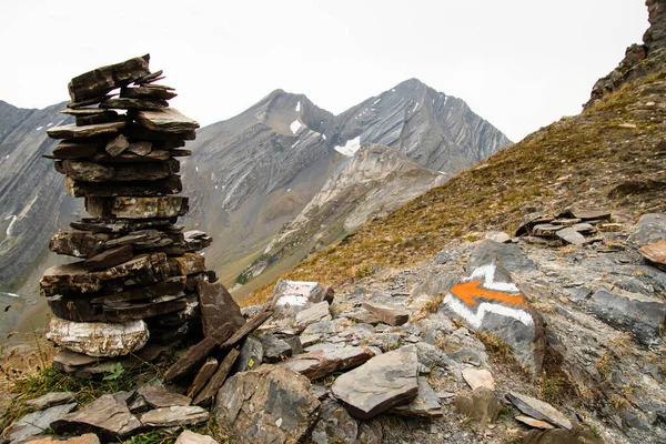 Painted directional arrow on rock. Alpine zone markings finding way on hiking trails concept outdoors. Hike rail Udziro lake in racha. Georgia caucasus mountains