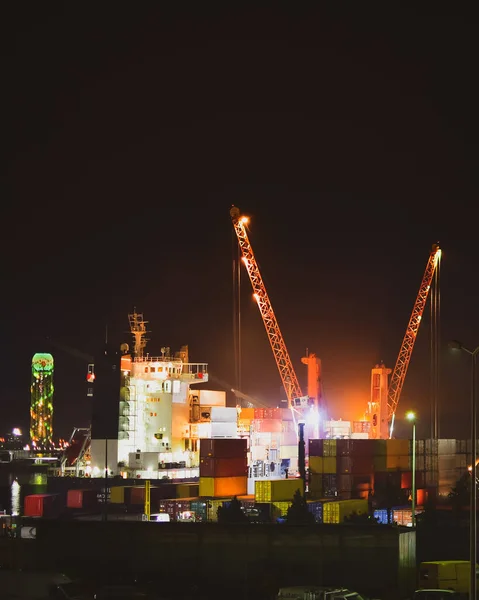 Loading cargo Ship In Batumi Sea port late at night work in darkness. Import export caucasus business industrial zone