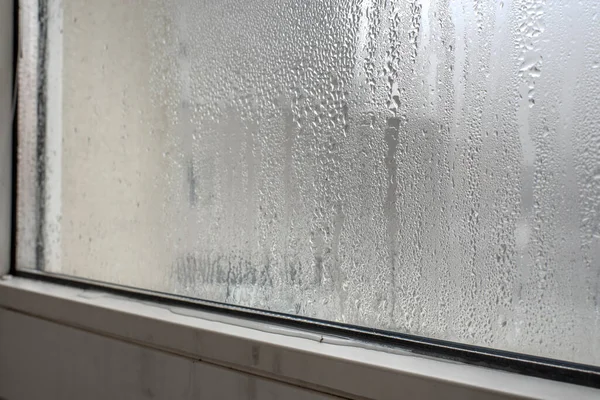 Typical winter window with a lot of condensated water. Window condensation. — Stock Photo, Image