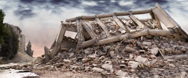 Çökmüş beton bir sanayi binasının üzerinde karanlık, dramatik bir gökyüzü. Hasarlı ev.