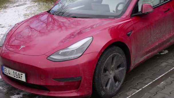 Roznov Czech Republic November 20th 2022 - Tesla model S car being charged with a yellow mussle car in background — Stock Video