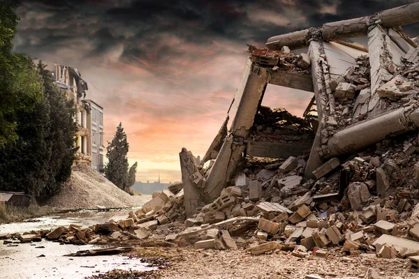 View on a collapsed concrete industrial building with dark red dramatic sky above. Damaged house and debris — Stock Photo, Image