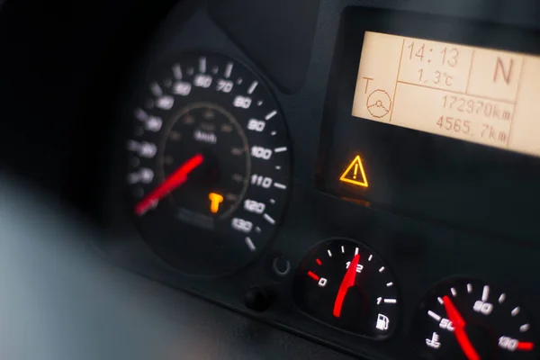 Capital T orange warning lit on speedometer of a heavy truck. Digital tachograph indicates 15 minutes left before the driver must take a brake after 4,5 hours of driving. — Stock Photo, Image