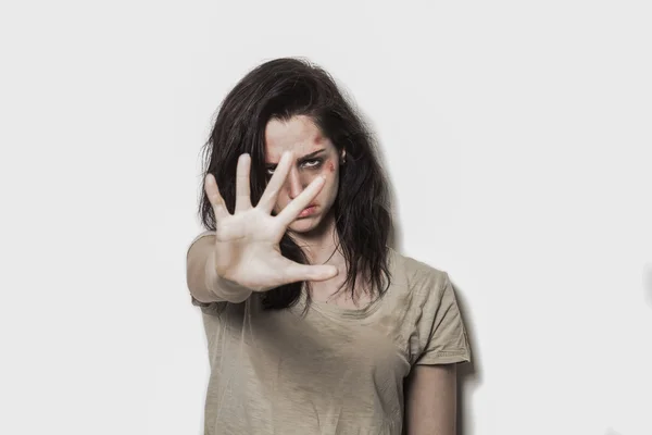 Beaten up girl asking to stop with strong look — Stock Photo, Image