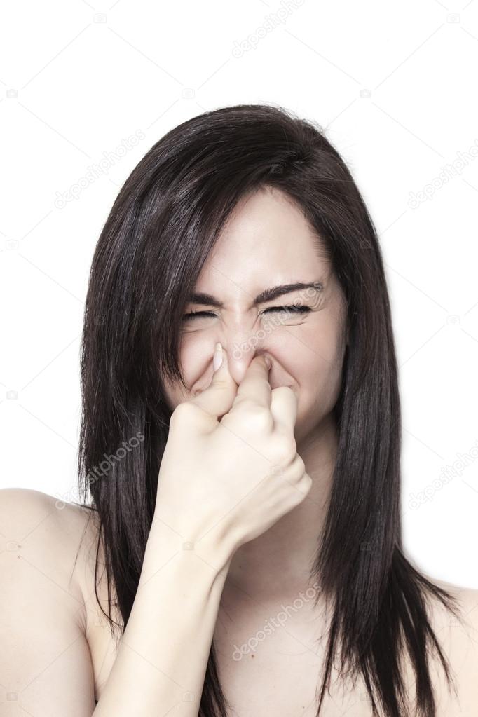 Girl smelling a bad odor