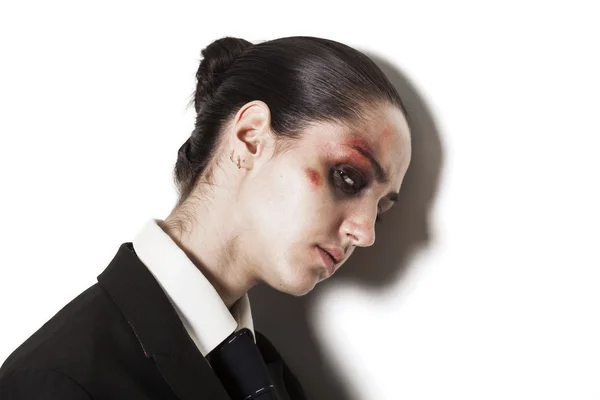 Beaten up girl wearing a suit and looking — Stock Photo, Image