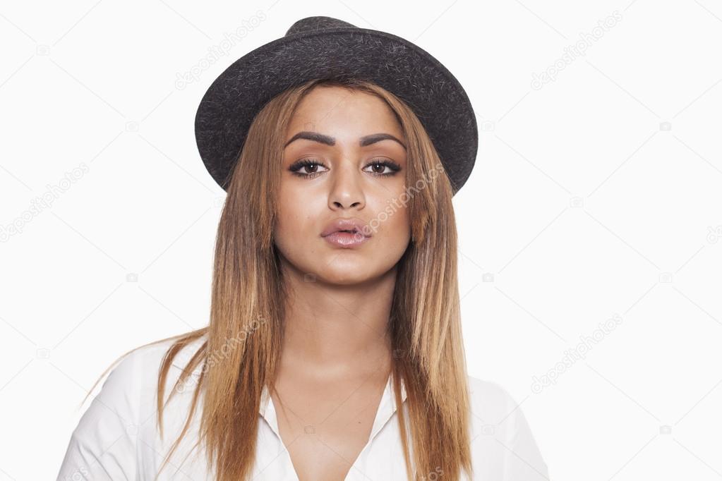 Woman wearing hat and shirt and looking