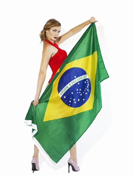 Sensual football supporter holding Brazil flag — Stock Photo, Image