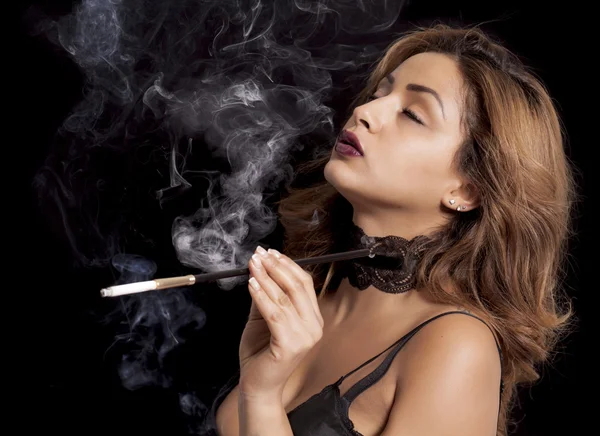 Sexy woman with cigarette holder smoking — Stock Photo, Image