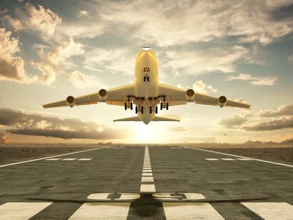 Airplane taking off at sunset