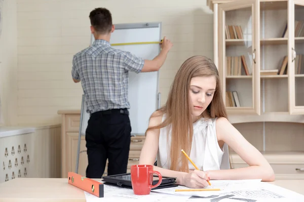 Two young architectures working at projective drawing — Stock Photo, Image