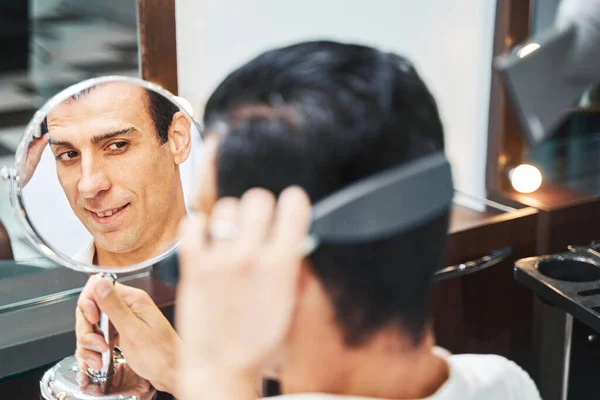 Ο άνθρωπος κοιτάζοντας τον καθρέφτη αισθάνεται αυτοπεποίθηση με νέο χτένισμα — Φωτογραφία Αρχείου