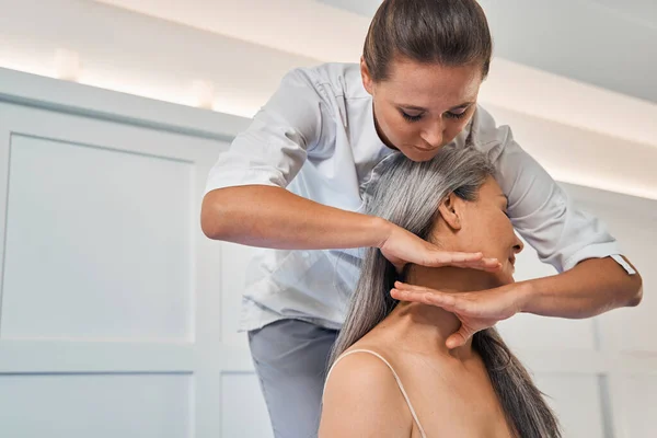 Focused photo on female hands massaging neck — Stock Photo, Image