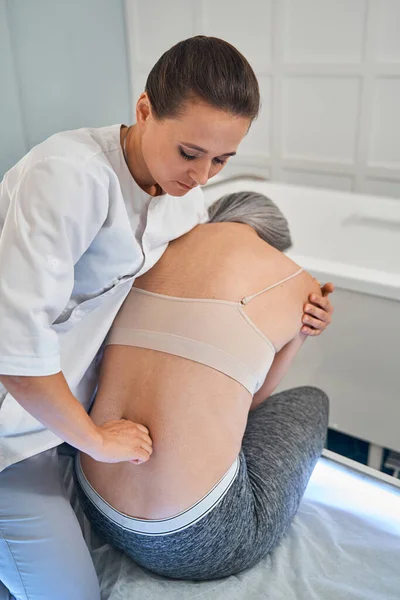 Trabajador médico joven haciendo tratamiento de rehabilitación profesional — Foto de Stock