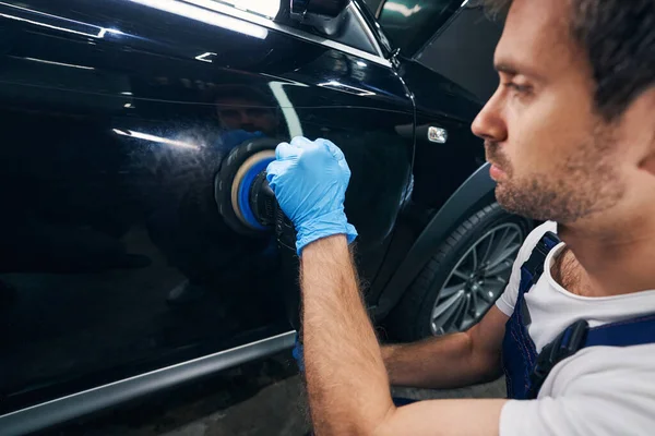 Car repair shop mechanic working away scratches with polisher — Stock Photo, Image