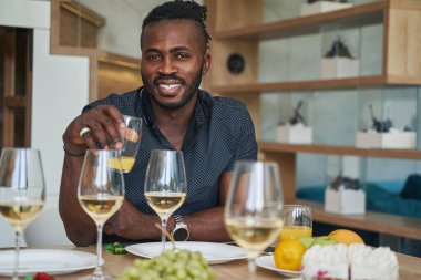 Mutlu genç adam büyüleyici bir gülümsemeyle kameraya bakıyor.