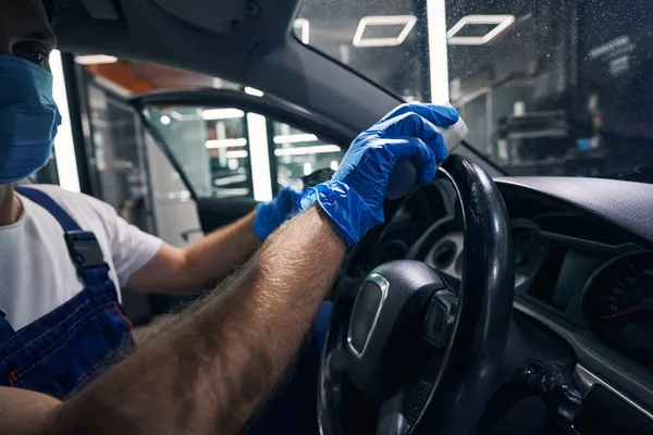 Hand of auto service specialist washing car wheel with sponge — Stock Photo, Image