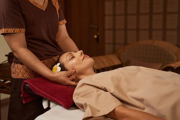 Placid spa client having her face massaged by masseuse — Stock Photo, Image