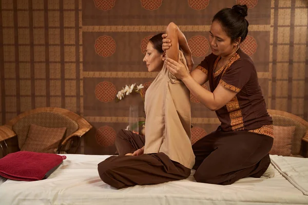 Serene spa client getting Thai stretching massage — Stock Photo, Image