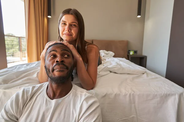 Joyous woman posing for camera with man in bedroom — Stock Photo, Image