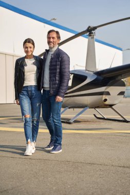 Helikopterin önünde yan yana duran sevimli çift.