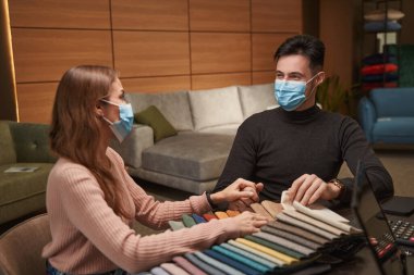 Kafkasyalı çift mağazada yeni döşeme kumaşı seçiyor