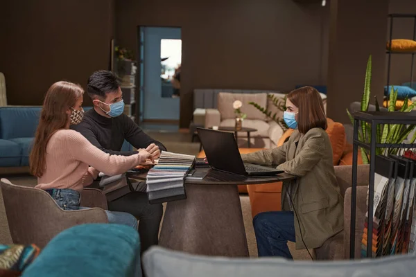 Satış memurunun desteğiyle döşemeci seçen müşteriler