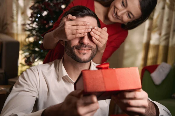 Bella dama haciendo sorpresa a su novio en la víspera de Navidad — Foto de Stock