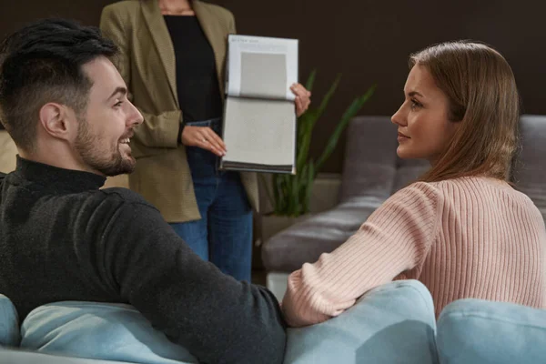 Couple selecting sofa upholstery material in shop — Stock Photo, Image