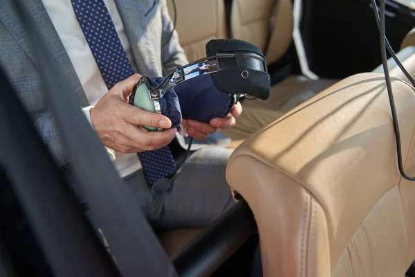 Man with headphones in hands sitting in helicopter — Stockfoto