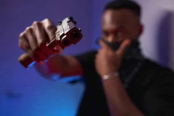 Male multiethnic American directing handgun into camera — ストック写真