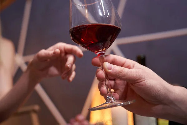 Glass of wine passed from one person to another — Stock Photo, Image