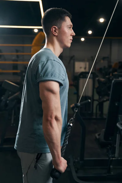 Konzentrierter Athlet macht Krafttraining an Seilmaschine — Stockfoto