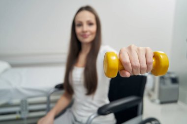 Fizyoterapi seansı sırasında güç egzersizi yapan engelli kişi