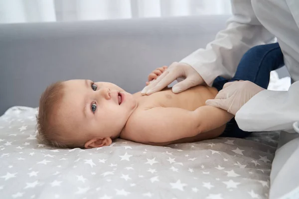 Physician pressing with hand on baby chest — Stock Photo, Image