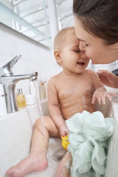 Happy smiling adorable kid washing in water from valve — Stock Photo, Image