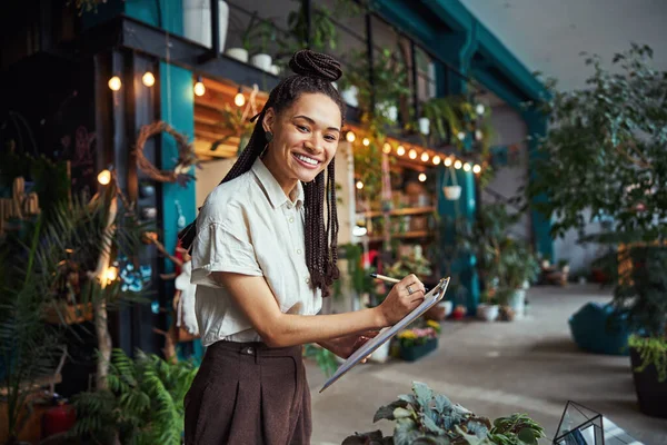 Joyful florist posing for the camera at work — Stock Photo, Image