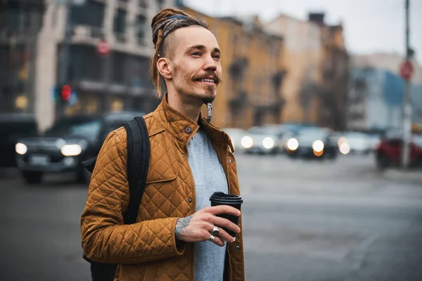 Smiling handsome hipster walking alone in city — Stock Photo, Image