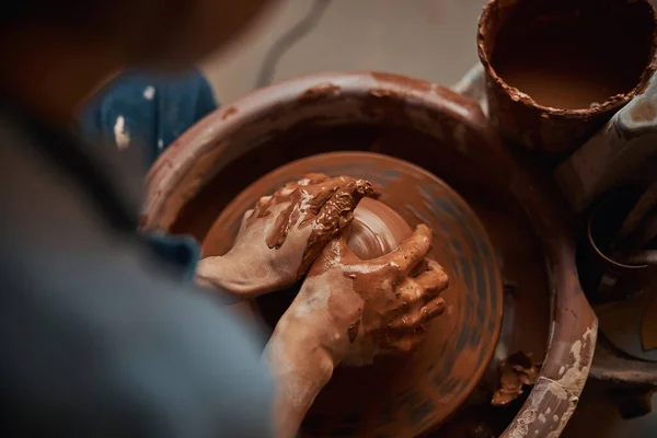 Céramiste professionnel non reconnu faisant pot d'argile sur la roue de poterie dans la salle à l'intérieur — Photo