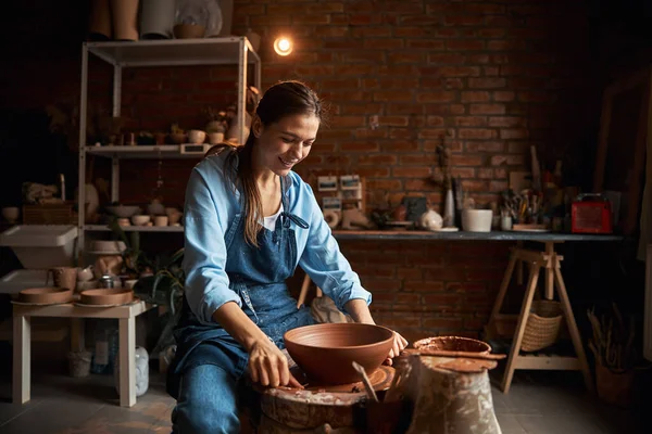아름다운 코카서스 기능공 여자가 현대식 도자기 작업장에서 도자기 그릇을 모델링 하는 모습 — 스톡 사진