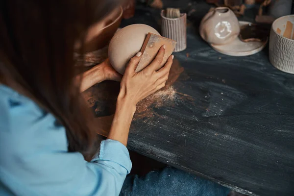 Hantverkskvinna i uniform modellering bordsartiklar i keramik verkstad — Stockfoto
