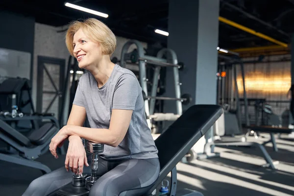 Glada kvinna vilar efter träning i gym — Stockfoto