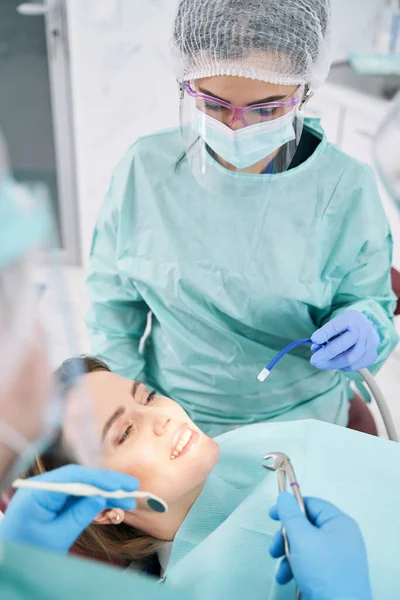 Woman receiving orthodontic treatment in stomatology clinic — Stock Photo, Image