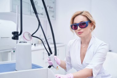 Sakin dermatolog lazer terapi seansına hazırlanıyor.