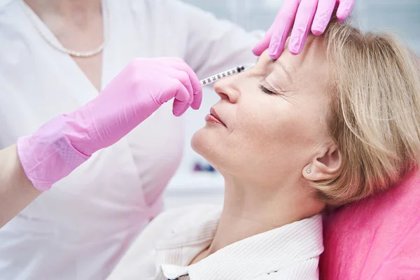 Close up of professional beauty master doing face injection — Stock Photo, Image