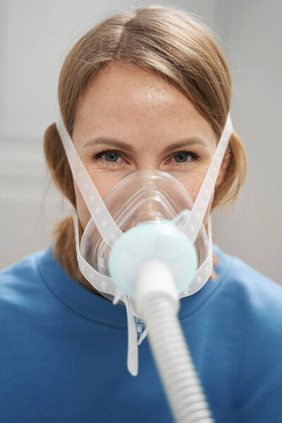 Женщина, получающая периодическую гипоксическую терапию в клинике