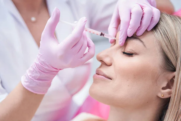 Female patient getting rid of frown wrinkles — Stock Photo, Image