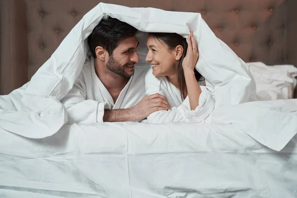 Wife and husband in bed under blanket — Foto de Stock